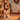 Dog wearing a Halloween-themed orange and black bandana and a Western-inspired pet ID tag, sitting in a cozy home decorated with pumpkins and autumn leaves.